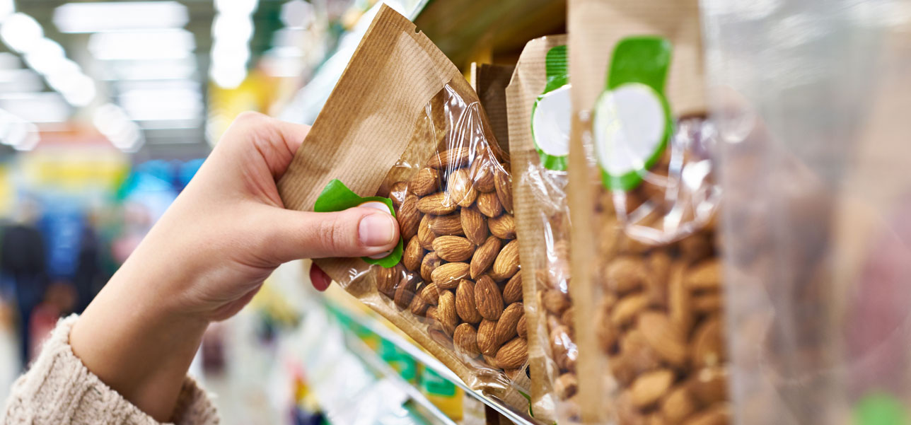 hand grabbing almond from shelf